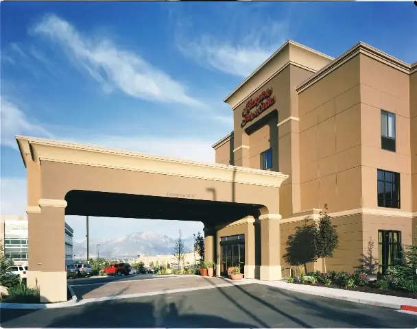 Hampton Inn and Suites West Jordan exterior with mountain backdrop